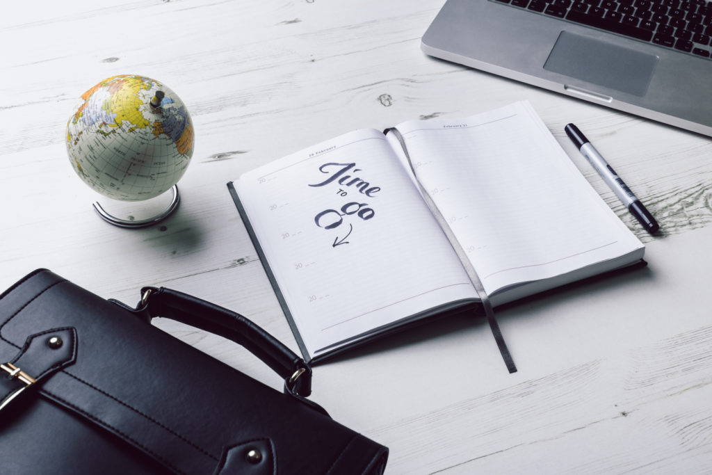 Book and briefcase on desk