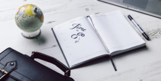 Book and briefcase on desk