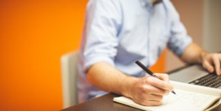 Man writing & Laptop