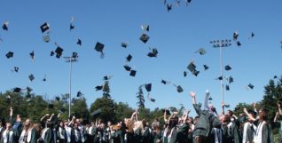 Graduates throwing caps in the air